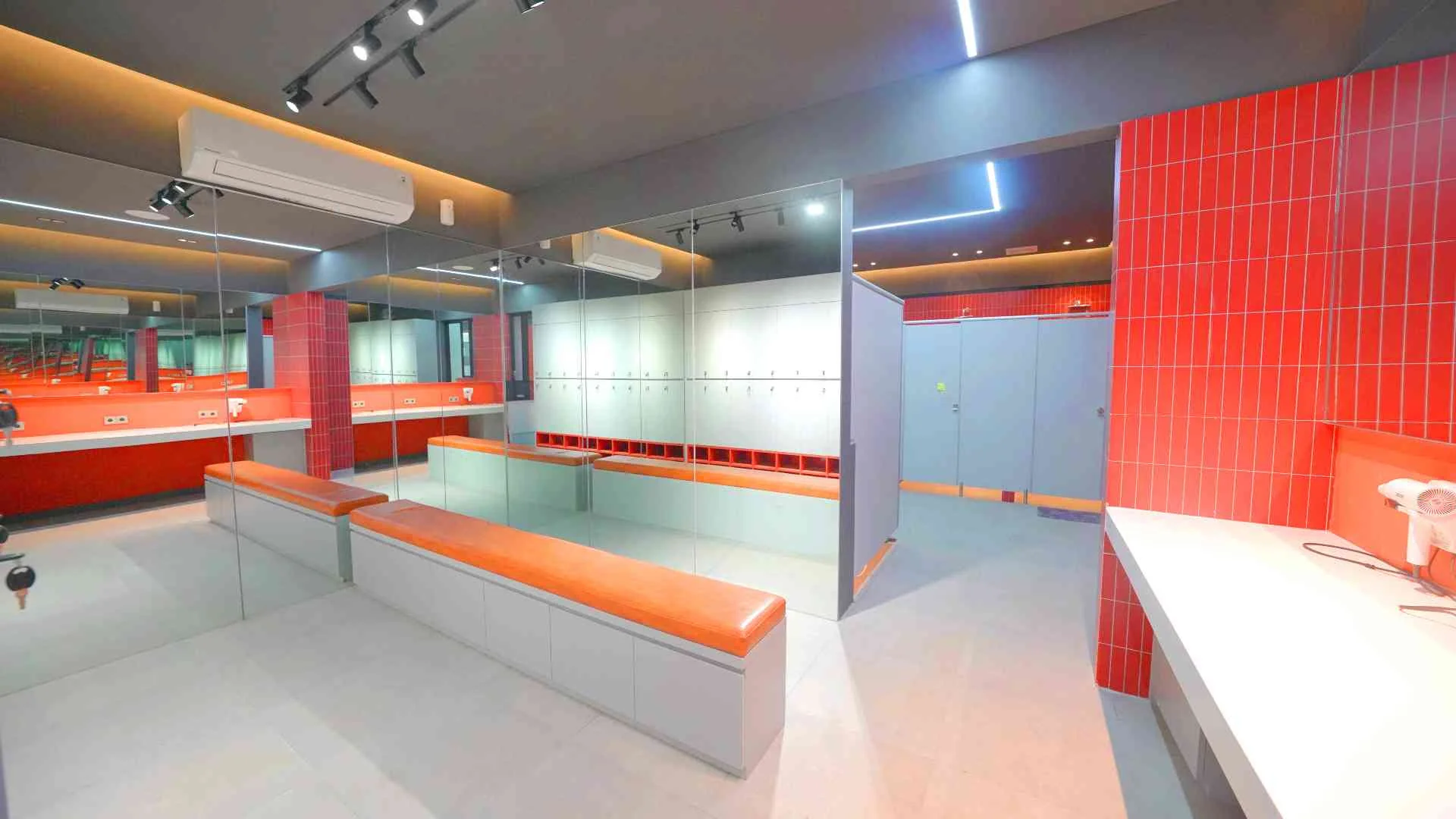 Locker room with timber benches, mirrors and showers