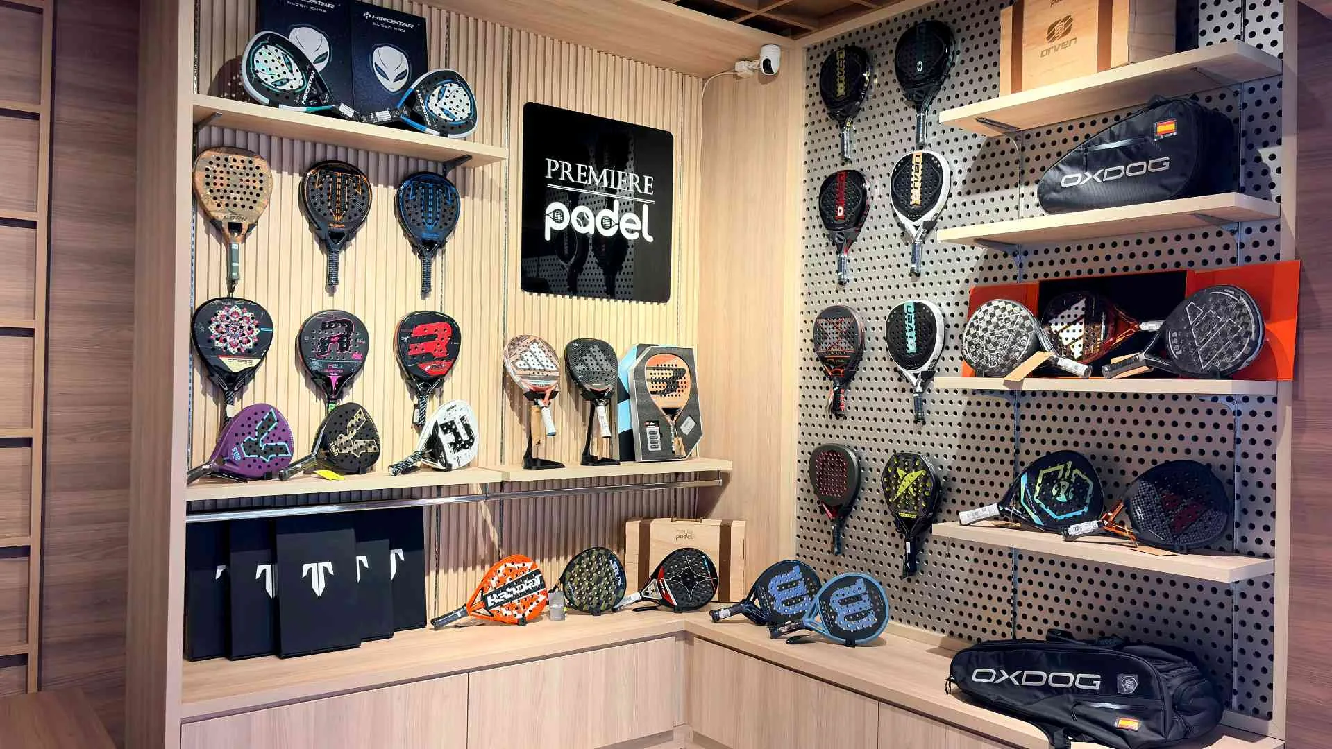 The Premiere Padel shop wall of rackets and bags